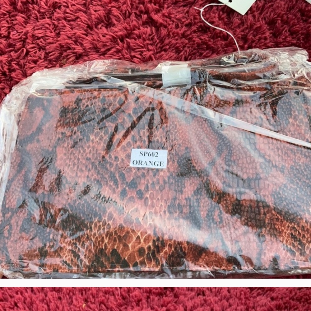 Orange snake print shoulder bags